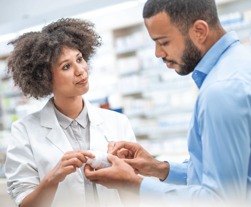 Pharmacist explaining about medication to a man