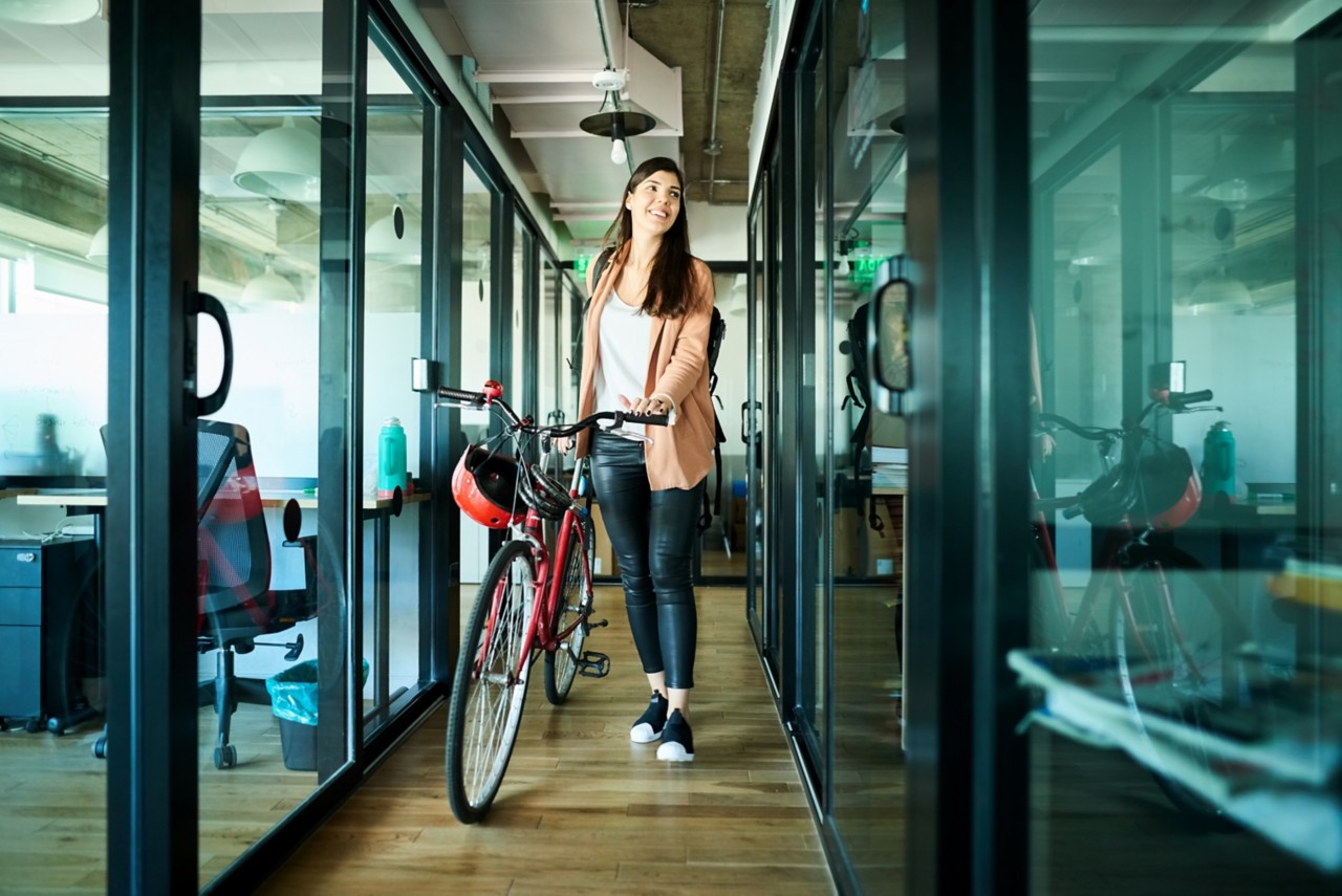 woman holding bike in the office